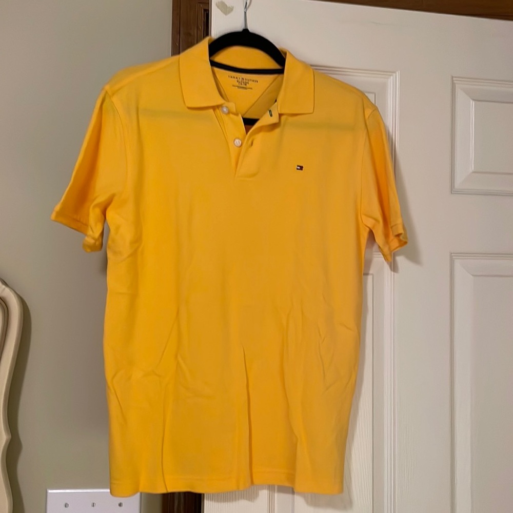 Tommy Hilfiger polo shirts. One yellow and one purple.